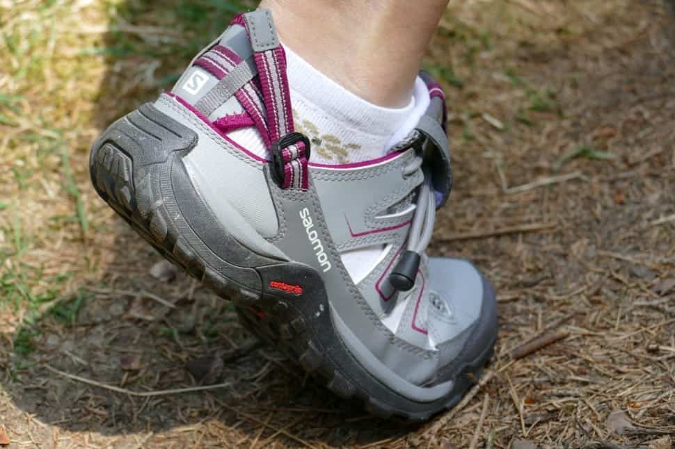 person wearing grey and pink hiking sports shoes